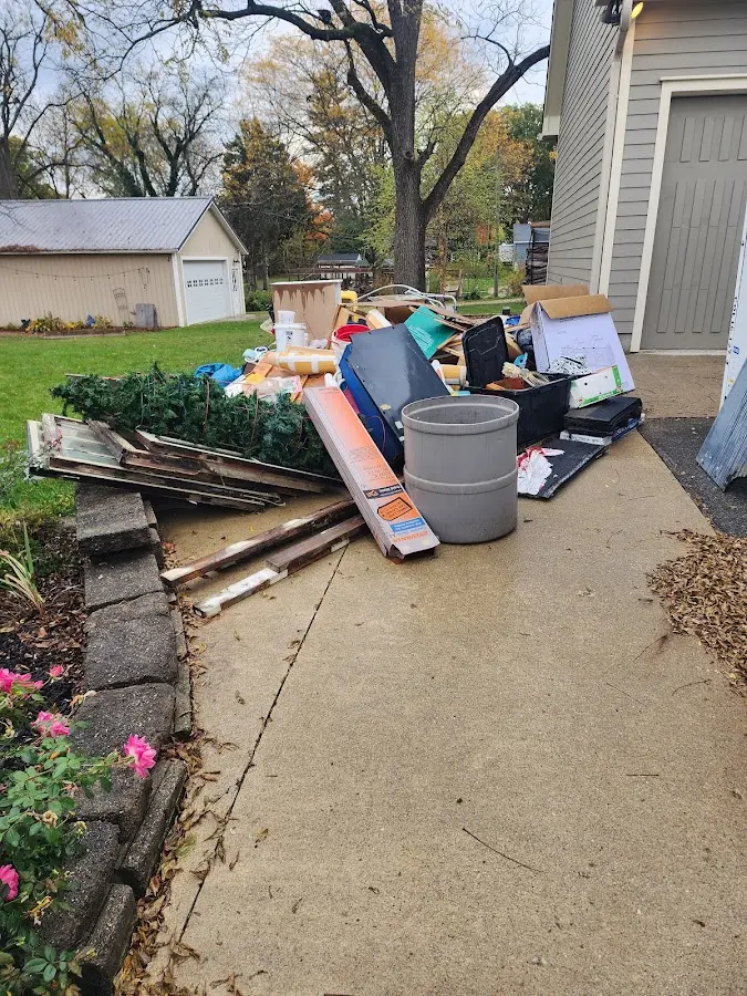 Dumpster being loaded with debris for Roofing Dumpster Rental in Kannapolis